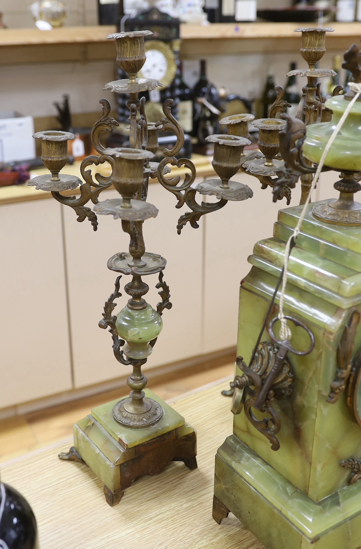 A French green onyx and bronze clock garniture, early 20th century, clock 50cm high